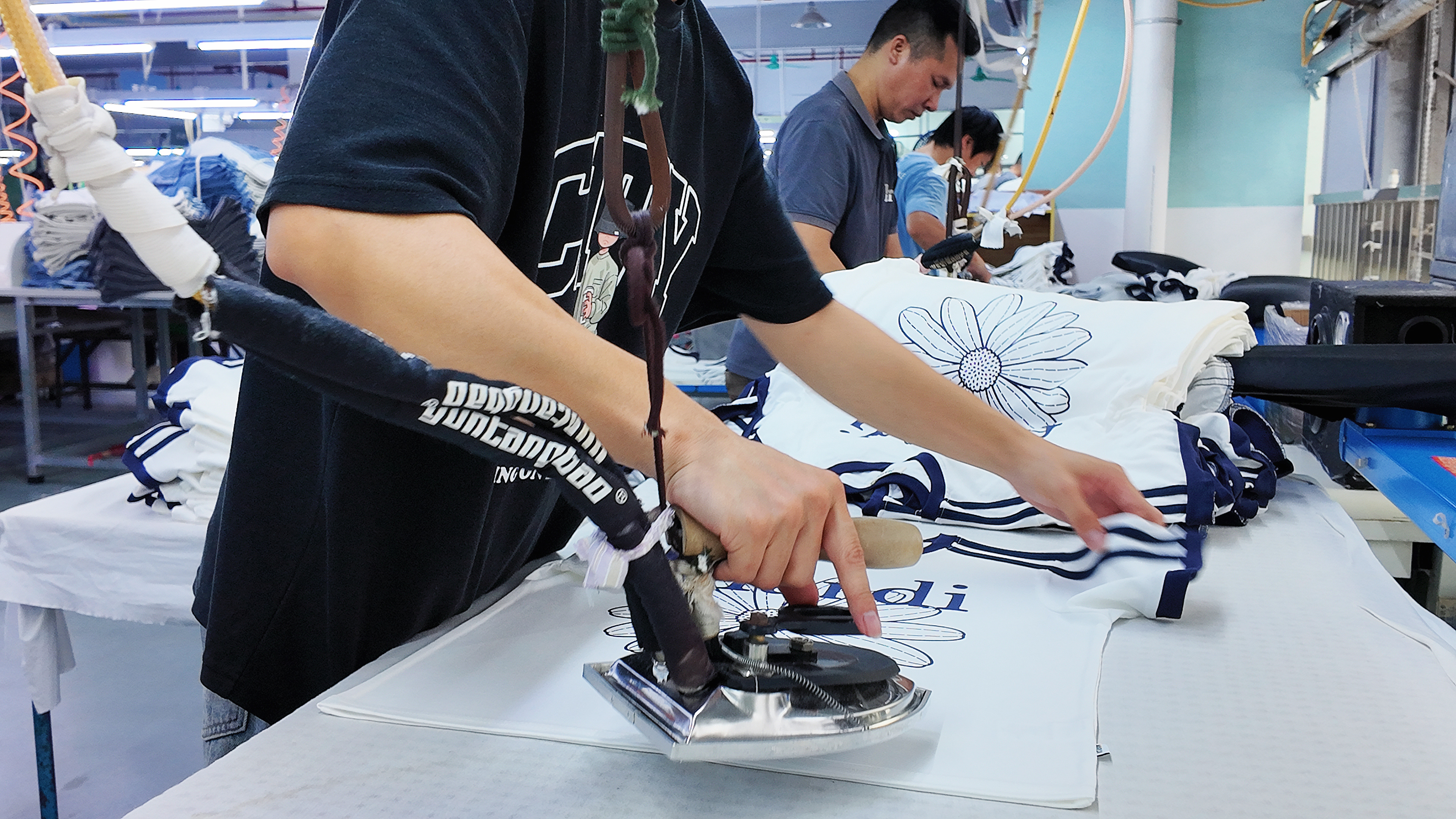 Ironing and finishing department at QICHENG clothing manufacturer
